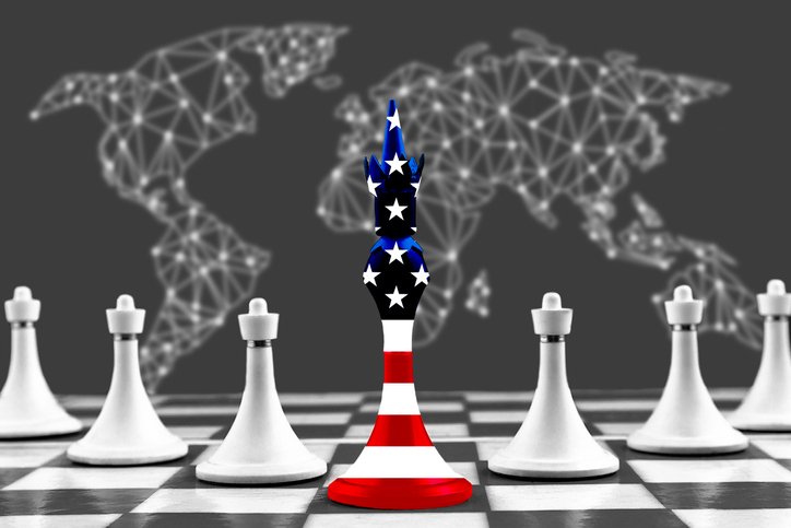 Chess piece King in the colors of the American flag with white pawns on a chessboard on the background of the world map.Image: iStock/Iryna Kushniarova Chess piece King in the colors of the American flag with white pawns on a chessboard on the background of the world map.Image: iStock/Iryna Kushniarova