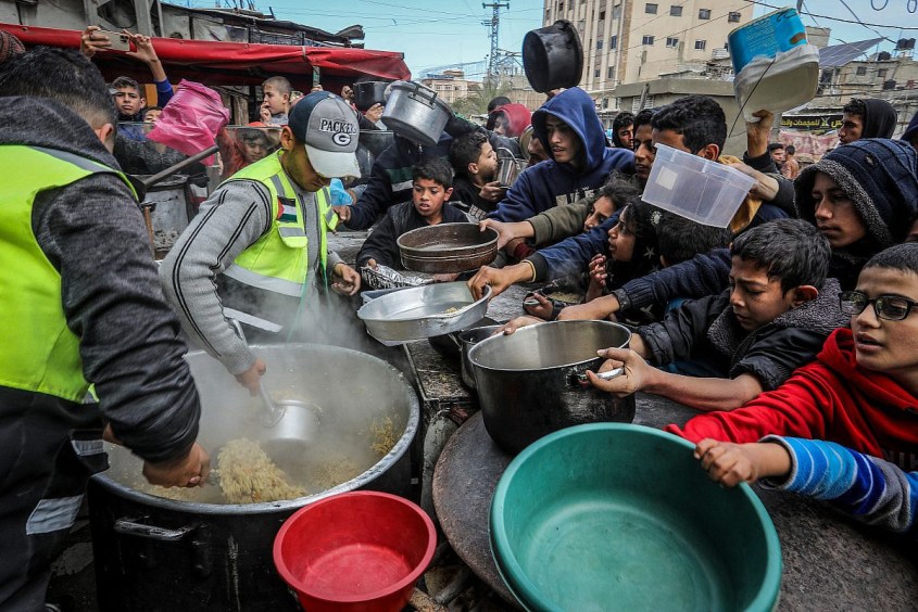 Palestinians wait for a hot meal prepared by volunteers in Rafah, southern Gaza Strip, January 26, 2024. (Abed Rahim Khatib/Flash90) Palestinians wait for a hot meal prepared by volunteers in Rafah, southern Gaza Strip, January 26, 2024. (Abed Rahim Khatib/Flash90)
