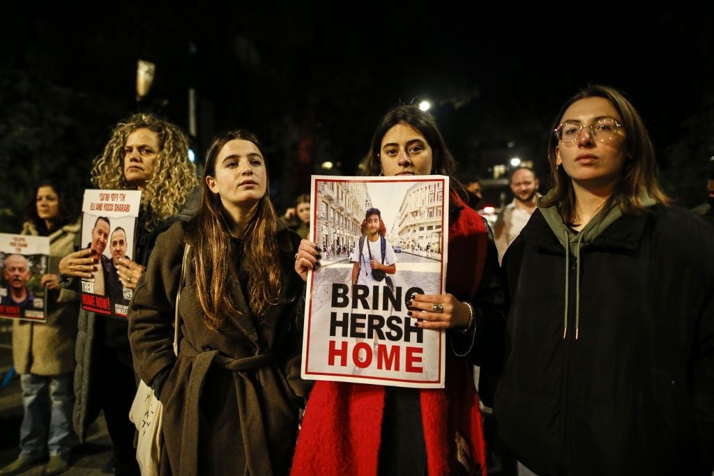 Families of Israeli hostages carry photos and banners marching to Netanyahu's residence