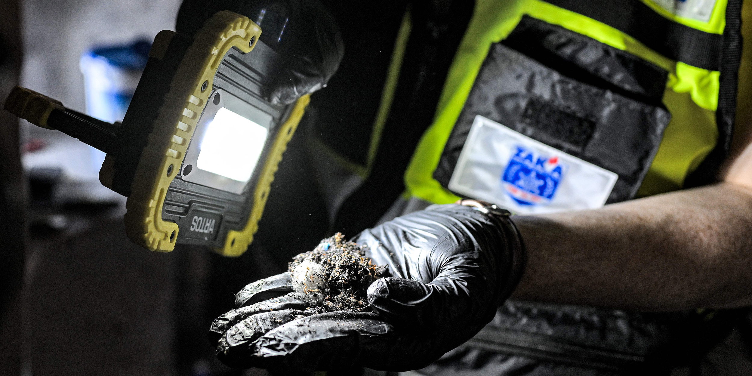 Volunteers of the Israeli ultra-Orthodox NGO ZAKA collect samples in one of the houses attacked by Palestinian militants on October 7, in Kibbutz Holit in Israel's southern district south of the Gaza Strip on October 26, 2023. Thousands of civilians, both Palestinians and Israelis, have died since October 7, 2023, after Palestinian Hamas militants based in the Gaza Strip entered southern Israel in an unprecedented attack triggering a war declared by Israel on Hamas with retaliatory bombings on Gaza. (Photo by YURI CORTEZ / AFP) (Photo by YURI CORTEZ/AFP via Getty Images)