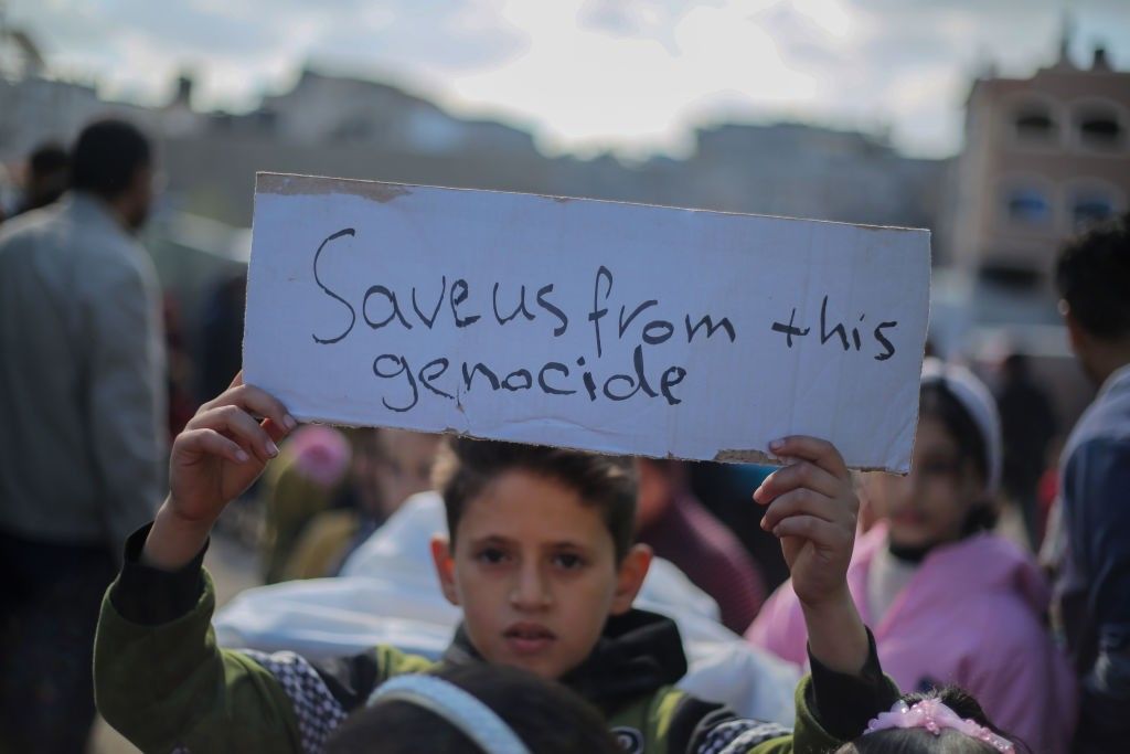 Palestinian children hold placards
