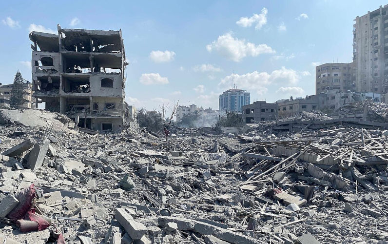Palestinians inspect the damage following an Israeli airstrike on the El-Remal aera in Gaza City on October 9, 2023.