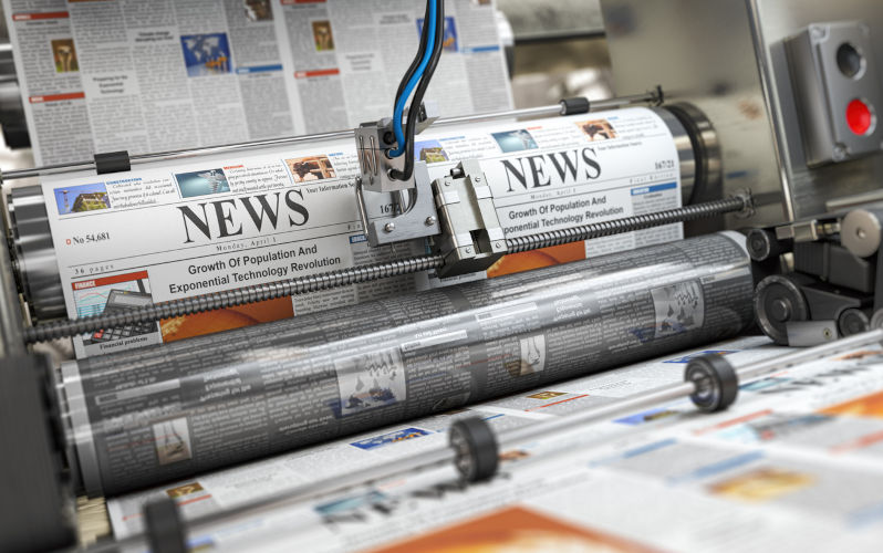 Newspaper or hournal with news printing on a printing machine in a typography. 3d illustration