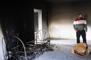 Palestinians inspect the damage to a house that was burned by settlers during a pogrom in Duma, occupied West Bank, April 14, 2024. (Oren Ziv)