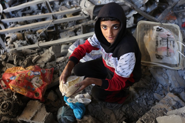 A Palestinian inspects the damage to the home of the Tabatibi family after Israeli bombardment in the Daraj Neighbourhood of Gaza on April 12, 2024, during the ongoing battles between Israel and the Palestinian Hamas movement. (Photo by AFP)