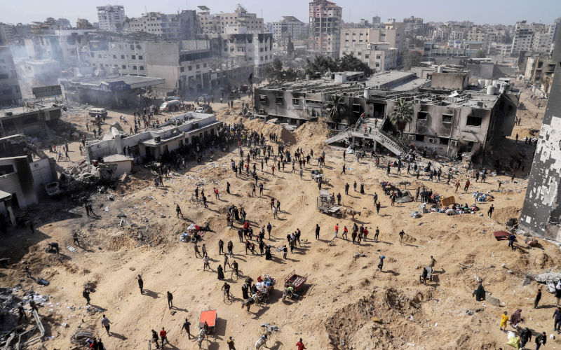 A general view as Palestinians inspect the damage at and near Al-Shifa Hospital after the Israeli army withdrew from it following a two-week military operation, in Gaza City, 01 April 2024. An Israeli army spokesperson reported that Israeli forces completed operations at Al-Shifa hospital with about 500 affiliated suspects arrested and 200 eliminated. More than 32,700 Palestinians and over 1,450 Israelis have been killed, according to the Palestinian Health Ministry and the Israel Defense Forces (IDF), since Hamas militants launched an attack against Israel from the Gaza Strip on 07 October 2023, and the Israeli operations in Gaza and the West Bank which followed it. Image: AAP/EPA/MOHAMED HAJJAR