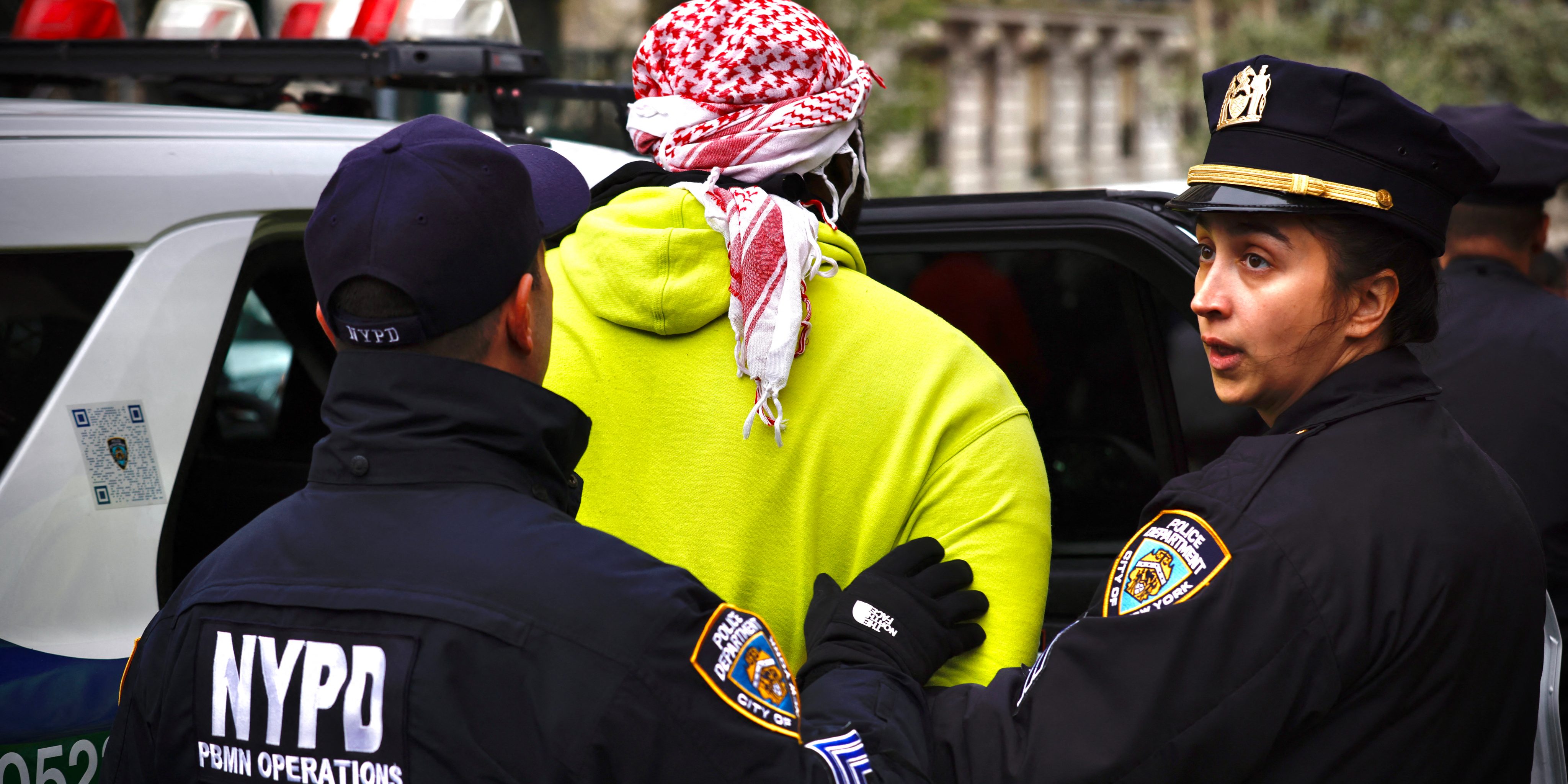 NYPD officers detain a person as pro-Palestinian protesters gather outside of Columbia University in New York City on April 18, 2024. Officers cleared out a pro-Palestinian campus demonstration on April 18, a day after university officials testified about anti-Semitism before Congress. Leaders of Columbia University defended the prestigious New York school's efforts to combat anti-Semitism on campus at a fiery congressional hearing on April 17. (Photo by Kena Betancur / AFP) (Photo by KENA BETANCUR/AFP via Getty Images)