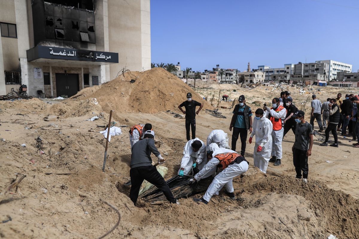 Palestinian civil defense workers remove bodies from rubble in Khan Younis.