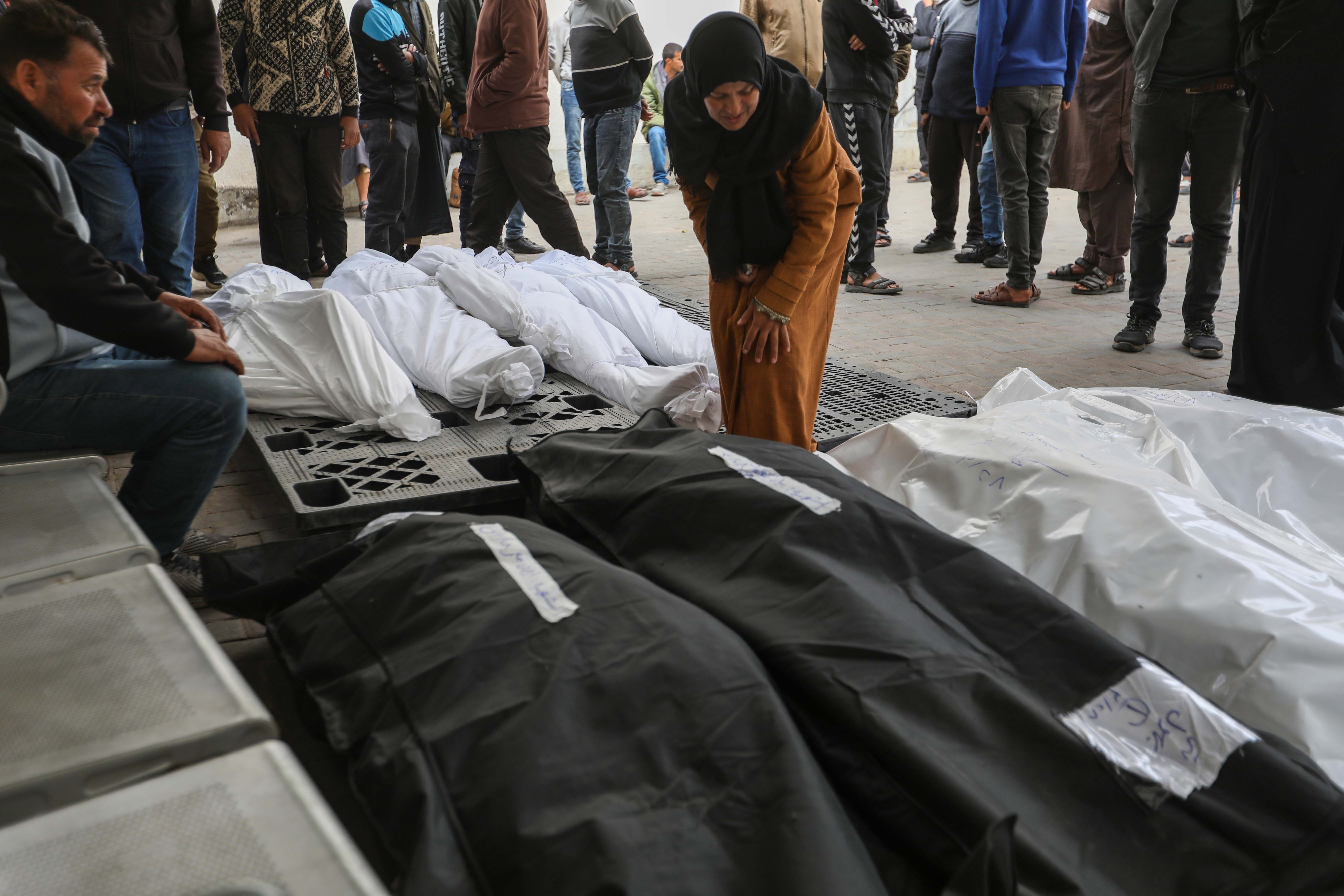 People mourn as they receive the dead bodies of victims  of an Israeli strike