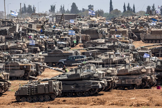 TOPSHOT - Israeli army main battle tanks and other military vehicles are positioned in southern Israel near the border with the Gaza Strip on May 9, 2024, amid the ongoing conflict in the Palestinian territory between Israel and the Hamas movement. (Photo by AHMAD GHARABLI / AFP) (Photo by AHMAD GHARABLI/AFP via Getty Images)