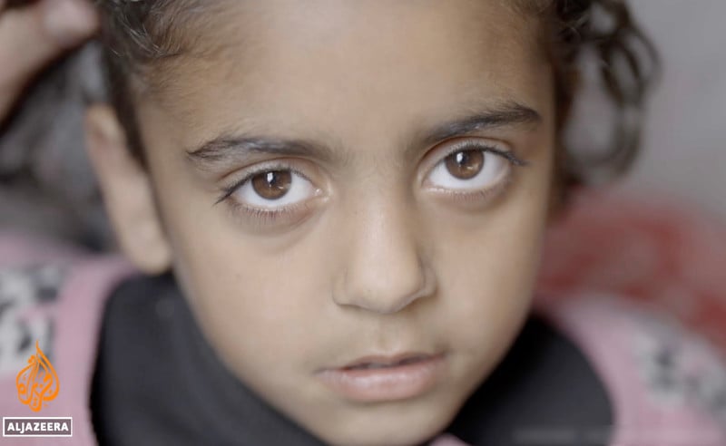 A Palestinian girl stares into the camera