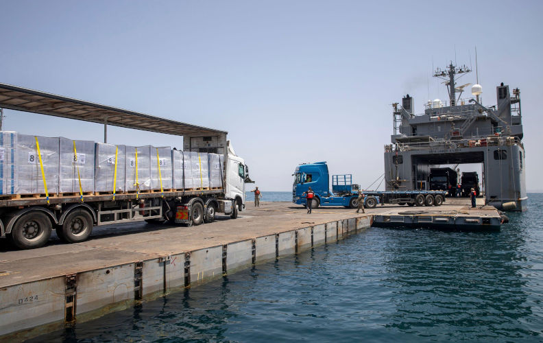 Mediterranean Sea, Israel. 21 May, 2024. A private truck moves humanitarian aid from the MV Roy P. Benavidez to the Roll-on Roll-off Distribution Facility and then by U.S. Army vessel LSV-6 to the Trident Floating Pier, May 21, 2024, in Gaza, Palestinian Territory. The floating pier will be used to move humanitarian aid directly from ships to land for the Palestinian people in Gaza. Credit: SSgt. Mikayla Fritz/US Army Photo/Alamy Live News